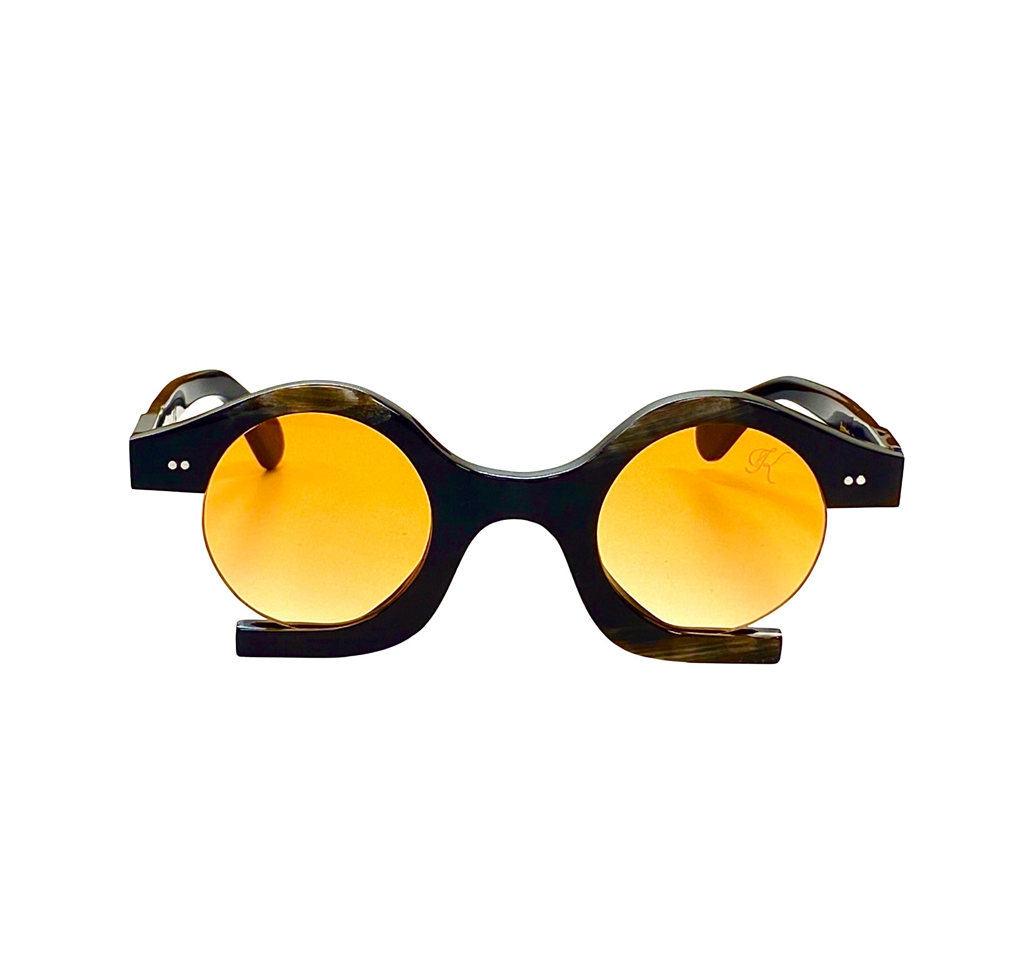 A pair of horn-framed sunglasses with orange gradient lenses - BOMBASTIC horn sunglasses with gradient orange lenses on face - Handcrafted horn frame and orange gradient lenses of BOMBASTIC sunglasses - bold horn frame and U-fit bridge design