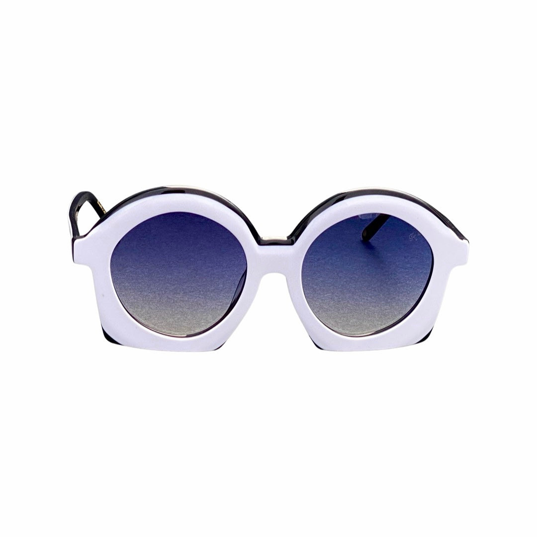 Wonderland sunglasses - A pair of white sunglasses with blue lenses resting on a surface