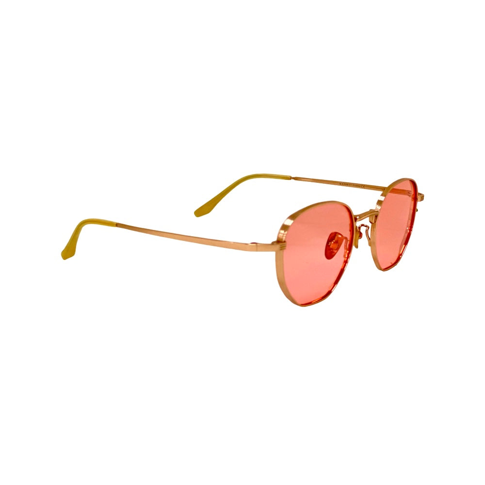 Sunglasses with gold frame and pink lenses - ROYOON being gently cleaned with microfiber 