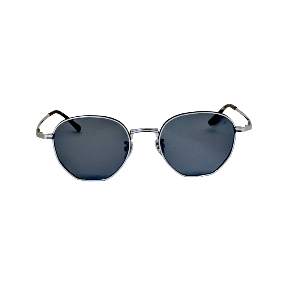 Sunglasses with dark lenses and thin metal frame - ROYOON sunglasses in a minimalist bamboo case - Lens demonstrating UV protection with a special light