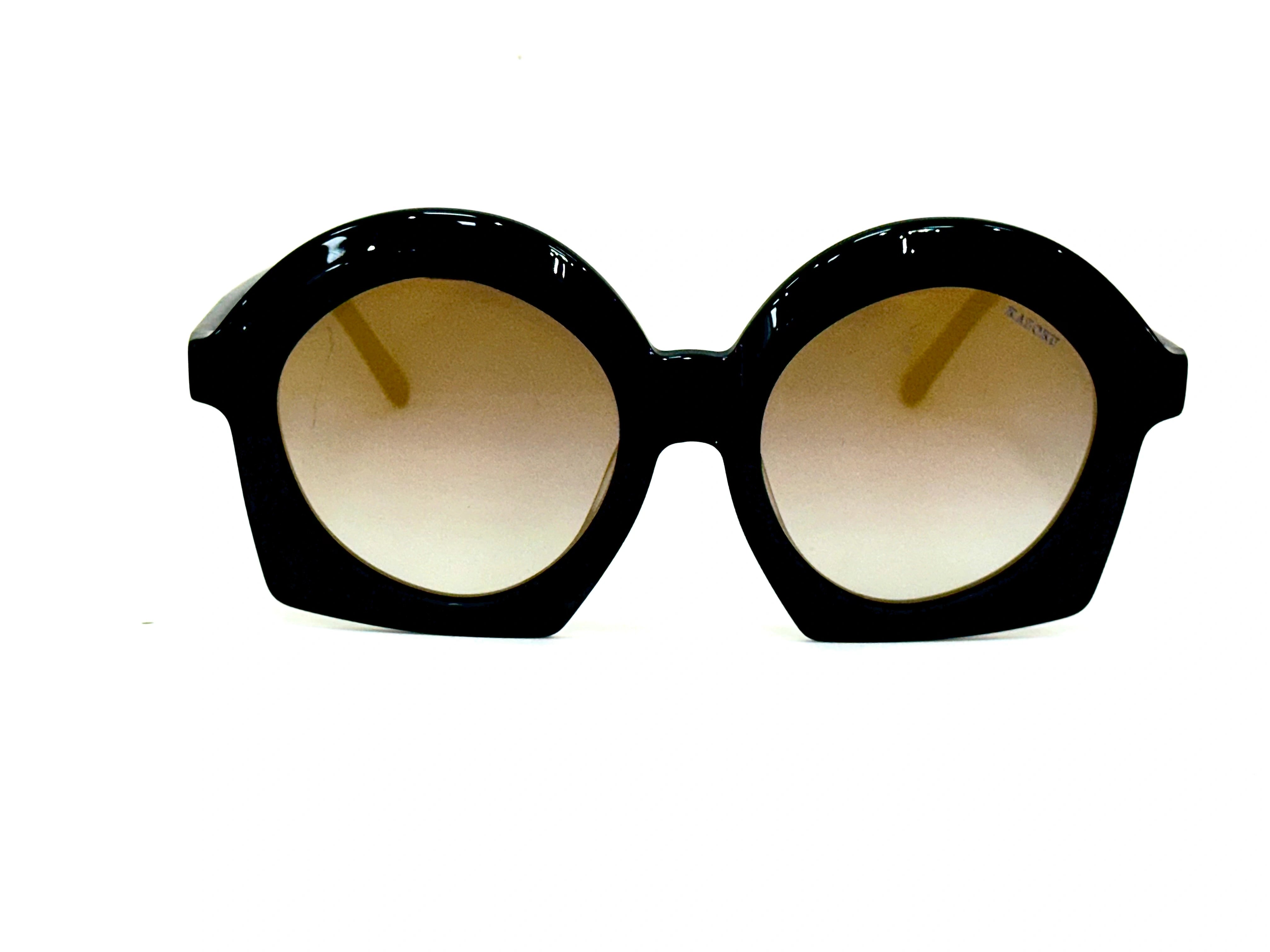 Black sunglasses with gold lenses - A pair of black sunglasses with yellow lenses, designed in an aviator style
