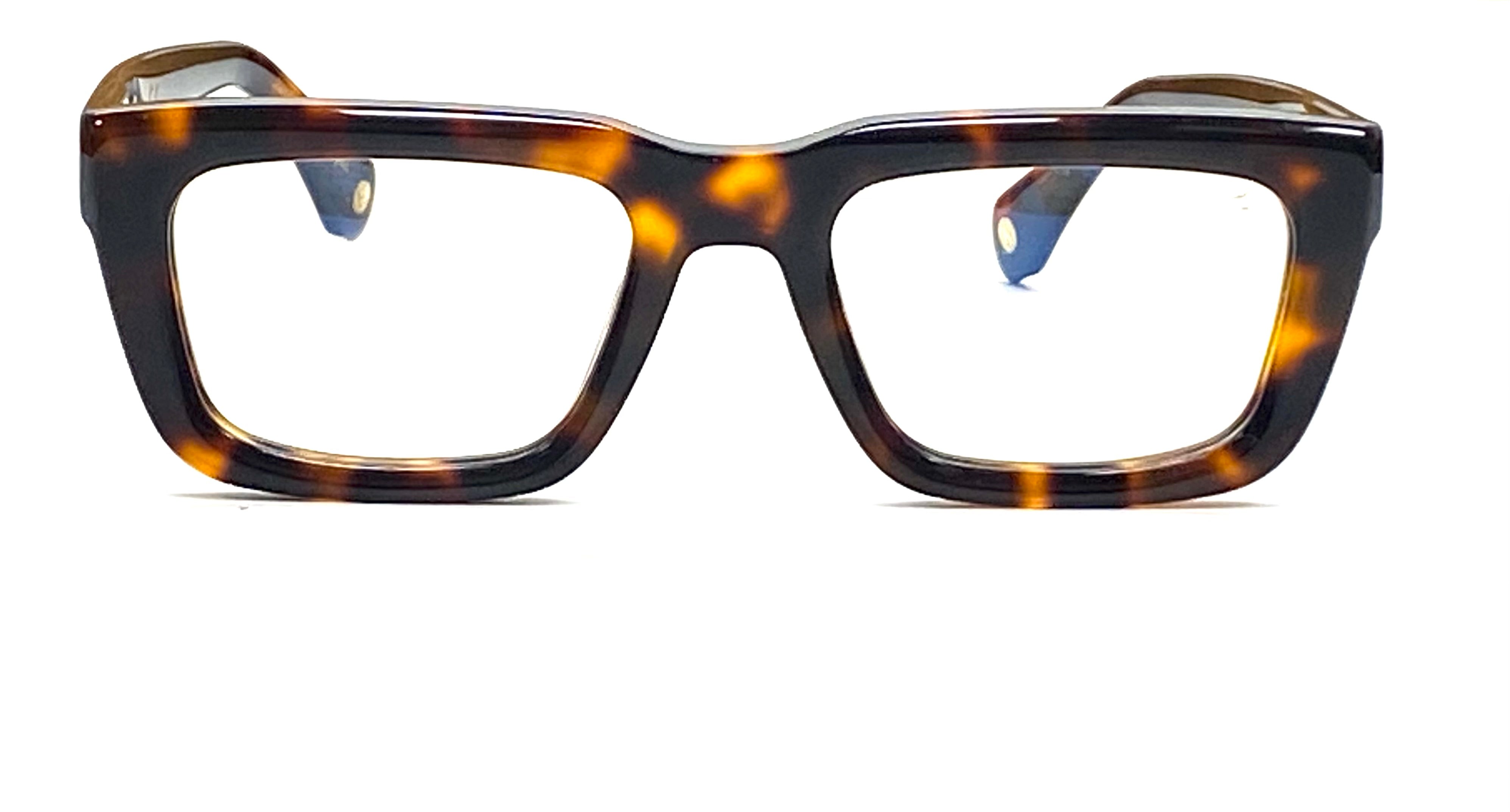 A pair of tortoise shell framed glasses resting on a flat surface, showcasing their unique pattern and design - Blue light filtering lens demonstration