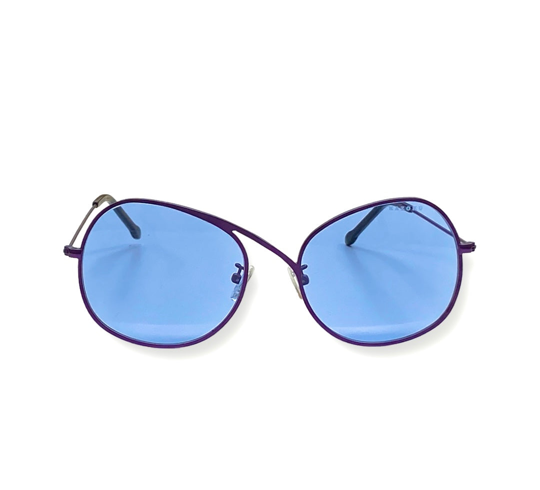 A pair of sunglasses with blue lenses resting on a flat surface - Comfortable nose pads close-up 
